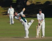 Grampound Rd. opener Tom Hughes hits a four. Wicket keeper is Gareth Davis.